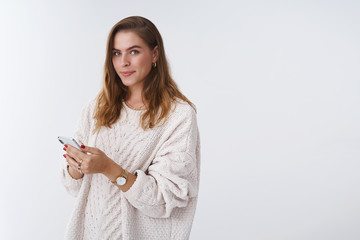 Portrait enthusiastic good-looking modern woman reading news using smartphone browsing web pages...