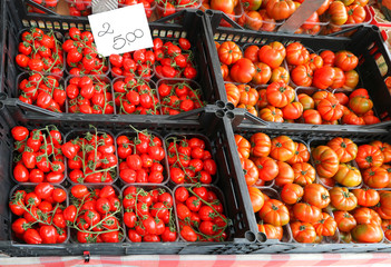 boxes of red ripe tomatoes with tag price