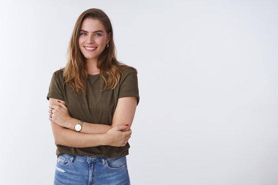 Wellbeing people lifestyle concept. Charming feminine tender outgoing young woman wearing olive t-shirt cross arms chest smiling cute flirty expressing positivity joyful attitude, white background