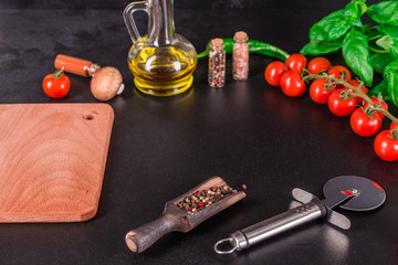 Obraz na płótnie Canvas Ingredients for preparation of tasty Italian pizza. Cherry tomato, spices, basil, chili pepper