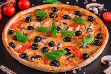 Tasty fresh hot pizza against a dark background. Pizza, food, vegetable, mushrooms