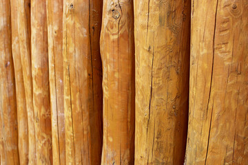 old red fence of vertical logs