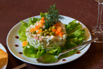 Traditional Azerbaijan salad Olivier Potato and mushroom salad with vegan mayo . On the plate capital Mayonnaise salad.