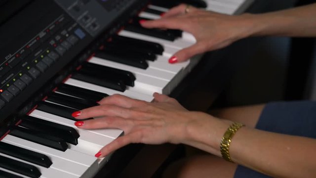 female hands playing the piano