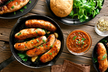 Fried sausages in frying pan - obrazy, fototapety, plakaty