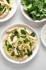 Spaghetti with spinach leaves, grilled chicken breast and cheese