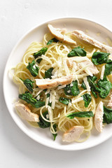 Spaghetti with spinach leaves, grilled chicken breast and cheese