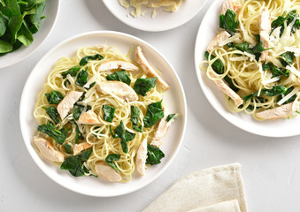 Spaghetti with spinach leaves, grilled chicken breast and cheese