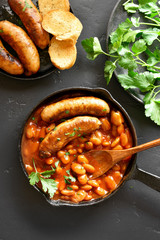 Sausages with baked white beans in tomato sauce