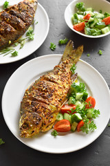 Cooked fish with healthy salad