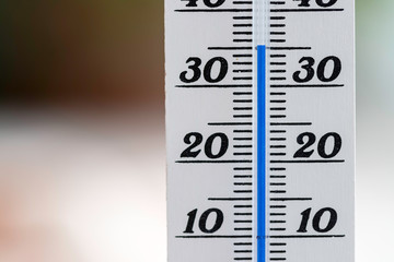 Heatwave: Thermometer in summer on a blurry background, heat