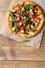 Vegetable italian pizza with tomatos on wodeen background