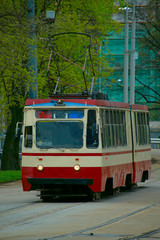 Fototapeta na wymiar old tram with burning lights at the tram stop