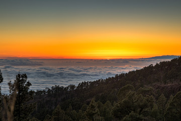 Fototapeta na wymiar magical sunset above the clouds in the Tenerife mountains in Canary Islands