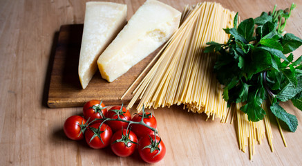 Healthy food. Vegetarian food. Nutritious food. Cheese, tomatoes, greens on a wooden background. place for text. copy space
