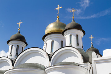 White church with golden domes on top with crosses