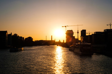 sunset sky over river spree in Berlin with Tv tower skyline -