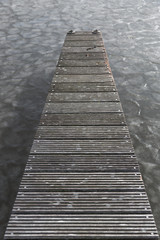 Wooden quay at frozen lake