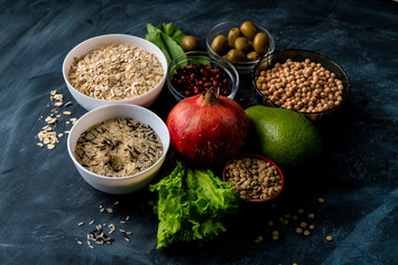 selection of healthy superfood on the chalkboard surface with fruit cereals and herb
