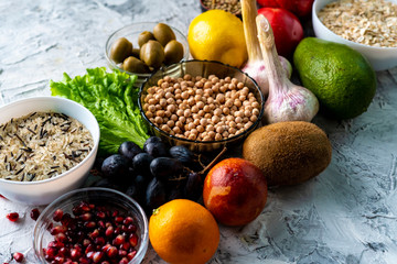 top view flat lay of healthy food selection with fruits vegetables seeds and green herbs on the tables © Mihail