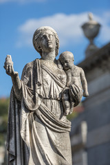 Statue of lady with baby at cemetery