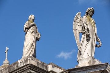 Mausoleum with lady and Angel on top at cemetery