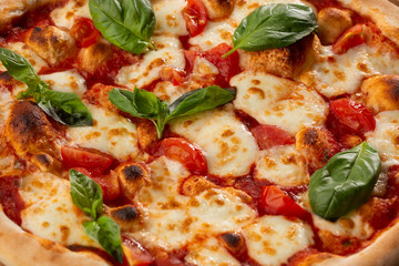 Pizza Margherita on wooden background, top view. Pizza Margarita with Tomatoes, Basil and Mozzarella Cheese close up. 