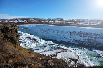 beautiful frozen waterfall in the south of Iceland