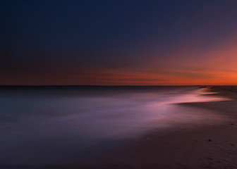 Coastline at the pacific ocean at sunset with long exposure