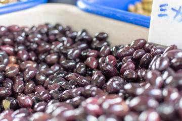 Traditional greek food ingredient, famous black kalamata olives in box on farmer market