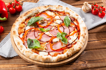Pizza on wooden background, top view. Pizza with pepper, ham,  Basil and Mozzarella Cheese close up. Flyer and poster for Restaurants or pizzerias, template with delicious taste  pizza.