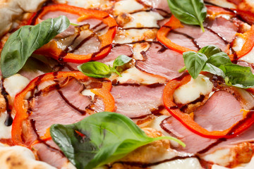 Pizza on wooden background, top view. Pizza with pepper, ham,  Basil and Mozzarella Cheese close up. Flyer and poster for Restaurants or pizzerias, template with delicious taste  pizza.