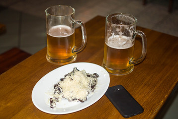 two glasses of beer on the table smartphone