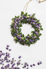 flat lay DIY flower wreath on white background 
