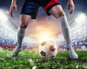 Soccer player ready to kick the soccerball at the stadium during the match.
