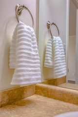 Bathroom interior with close up view of a white towel hanging on a towel ring