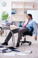 Young male employee unhappy with excessive work 