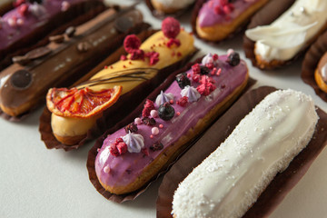 Set of several eclairs with various fillings and design isolate on a white background, the concept...