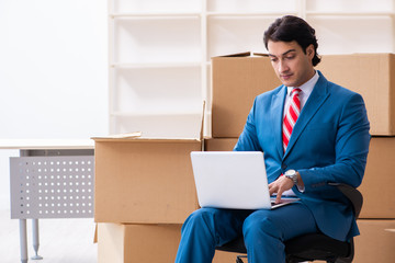 Young handsome businessman moving to new workplace 