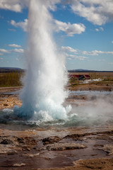 Fototapeta na wymiar An erupting geyser in Iceland on a sunny day