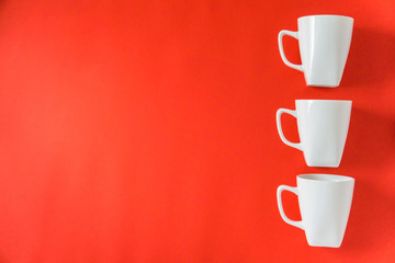 3 winter coffee cup mugs lined up for a break time meeting; Copyspace with empty room space for copy text;