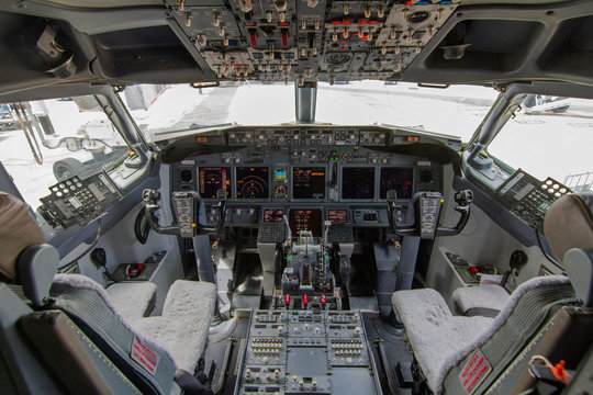 A view of the cockpit of a large commercial airplane a cockpit . Cockpit view of a aircraft cruising Control panel in a plane cockpit.
