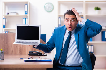 Young handsome businessman sitting in the office 