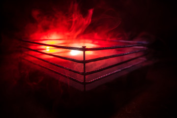 Empty boxing ring with red ropes for match in the stadium arena. Creative artwork decoration