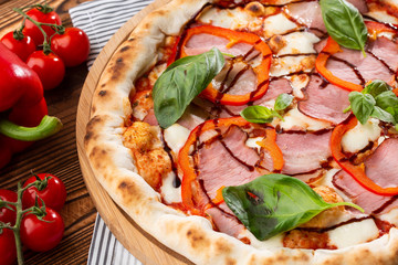 Pizza on wooden background, top view. Pizza with pepper, ham,  Basil and Mozzarella Cheese close up. Flyer and poster for Restaurants or pizzerias, template with delicious taste  pizza.