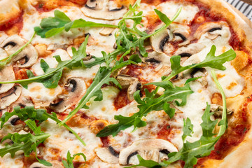 Italian Delicious Fresh Hot Mix Baked Pizza with Melting Cheese, sliced mushrooms , tomato sauce and cheddar serving on textured rustic background. Mushrooms pizza. top view.