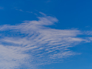 Naklejka na ściany i meble Blue sky background with clouds and sunlight.