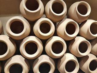 Clay pots in light brown stacked horizontal forming symmetry as decoration