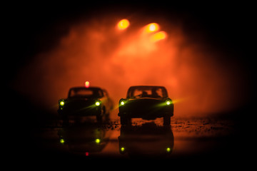 Obraz na płótnie Canvas Police car chasing a car at night with fog background. 911 Emergency response police car speeding to scene of crime. Selective focus