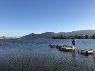 A lord fishing on an old deck.